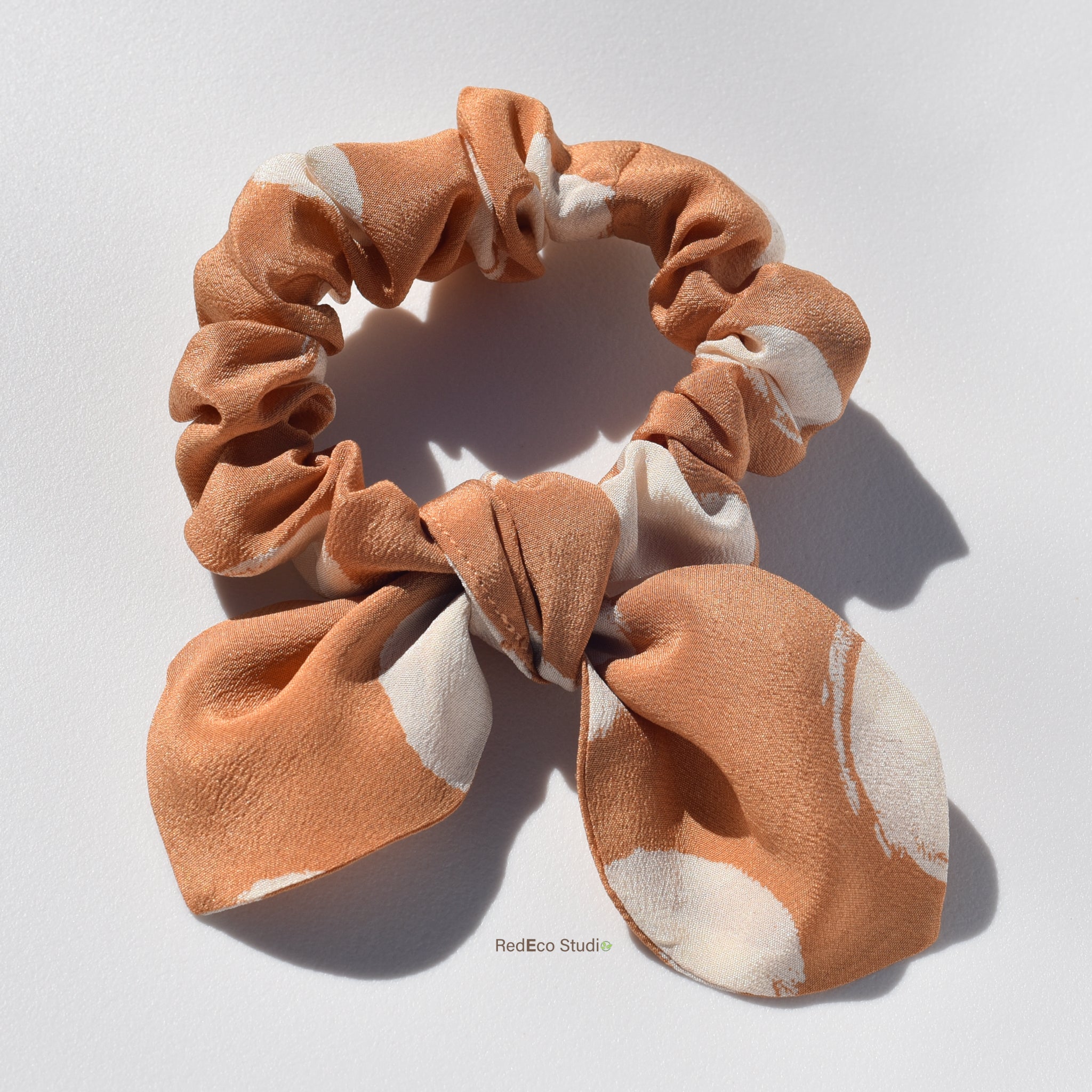 Mini pure silk scrunchie with bow on light background
