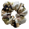 Floral scrunchie in neutral colours on a light gray background