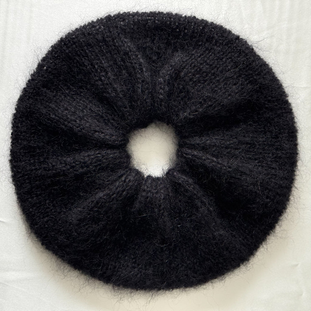 Black extra large hand-knitted scrunchie on a light background.