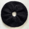 Black extra large hand-knitted scrunchie on a light background.