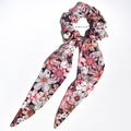 Large Floral silk scrunchie with pink and white flowers and long tails on a white background