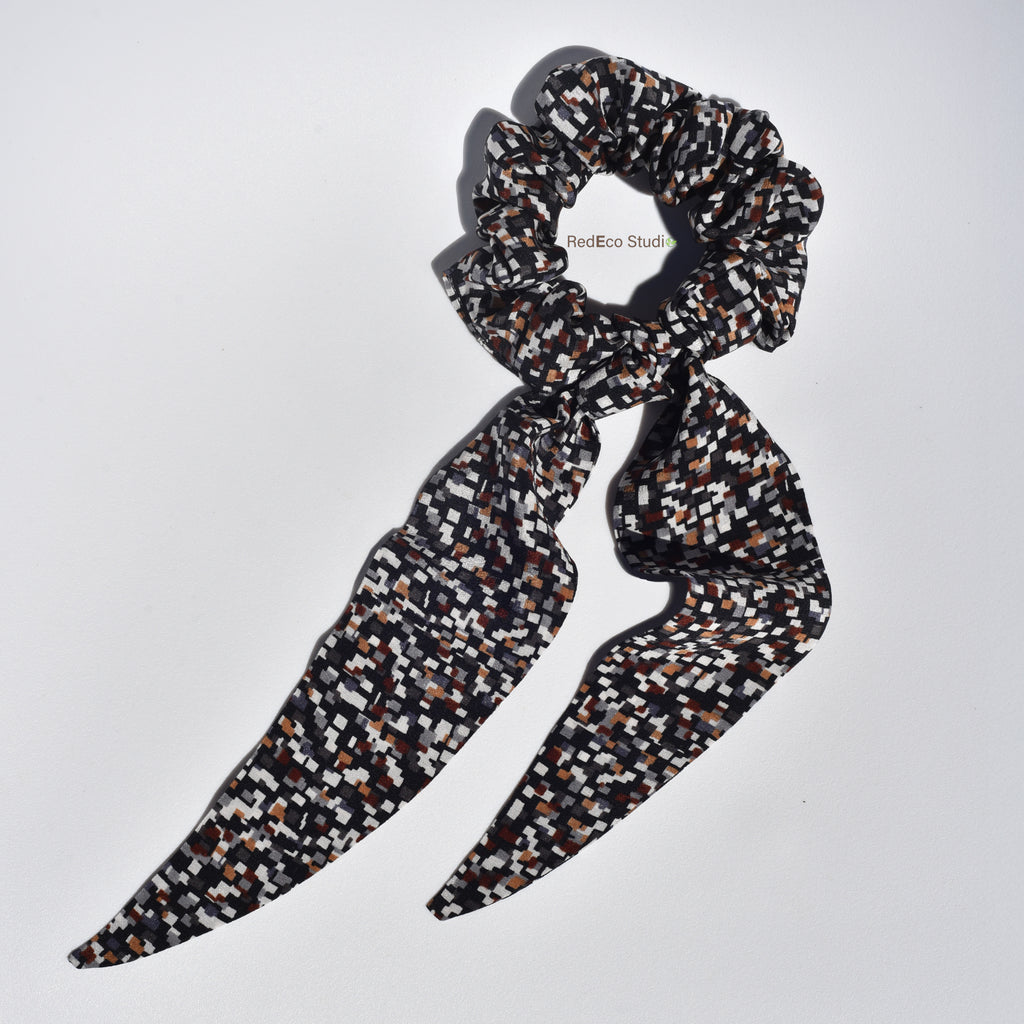 Medium patterned hair silk scrunchie with long tails on a white background