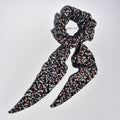Medium patterned hair silk scrunchie with long tails on a white background