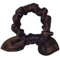 Brown satin scrunchie on a light gray background