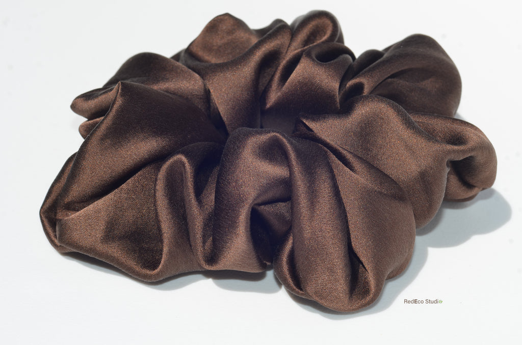 Brown satin scrunchie on a white background