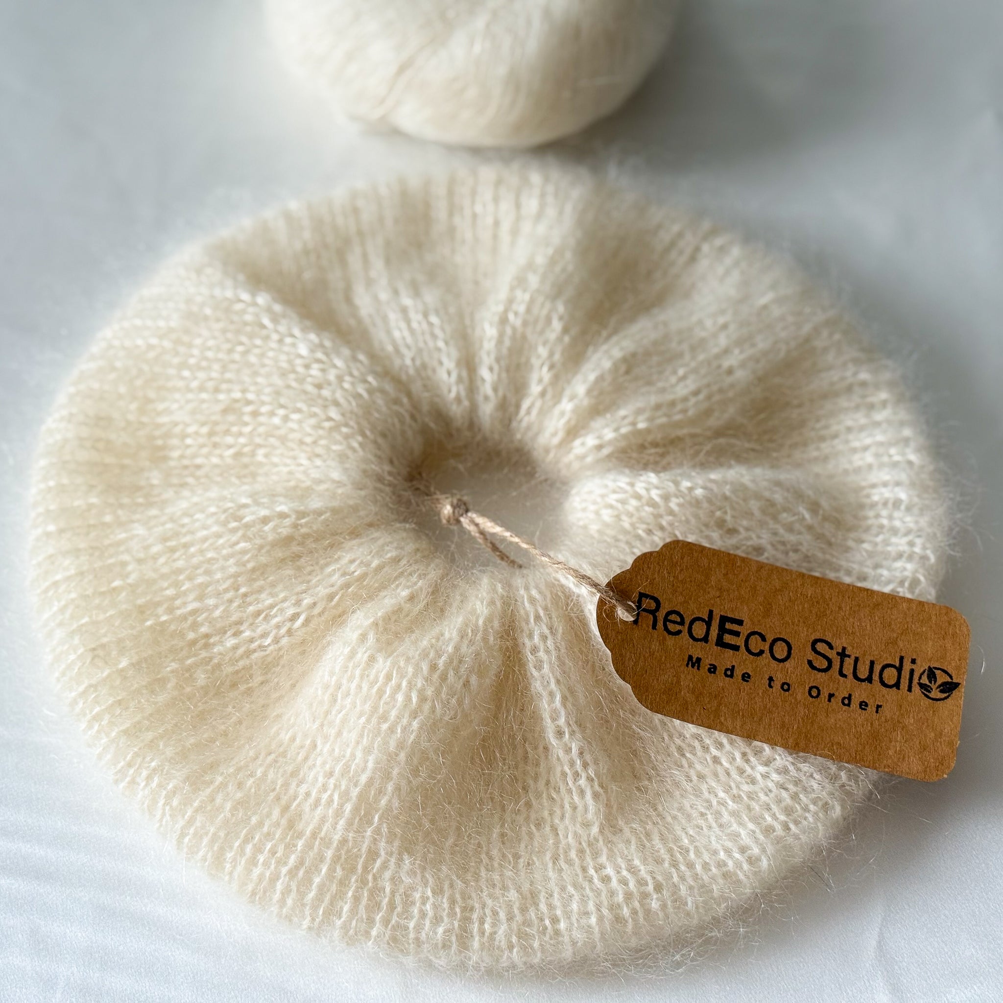 Beige scrunchie with a 'RedEco Studio' tag on a white background
