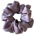 Purple scrunchie on a light gray background