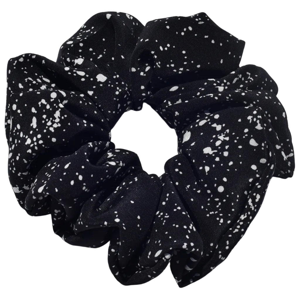 Large black silk scrunchie with white speckles on a light gray background