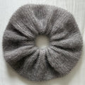 Light Grey knitted scrunchie on a light background.