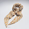 Medium floral pure silk scrunchie with long tails on a white background