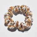 Mini floral patterned premium silk scrunchie on a white background