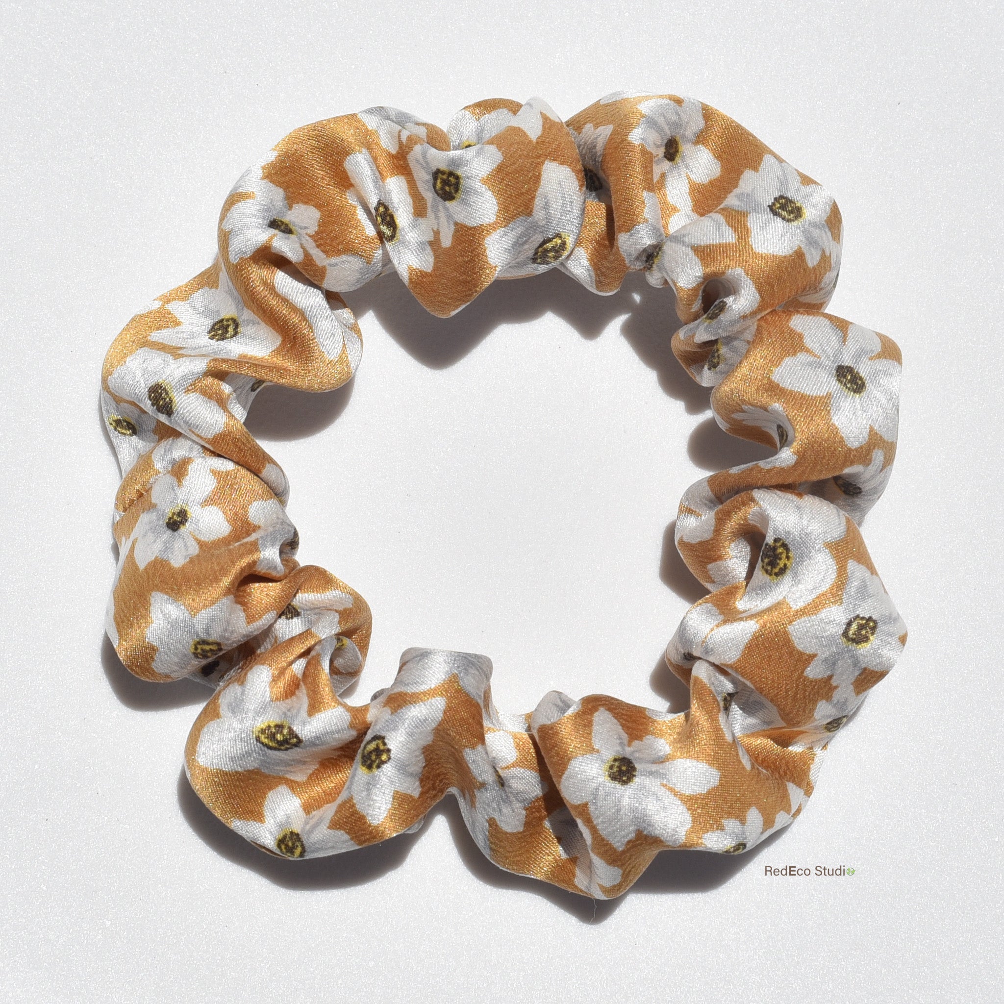 Small floral patterned pure silk scrunchie on a white background
