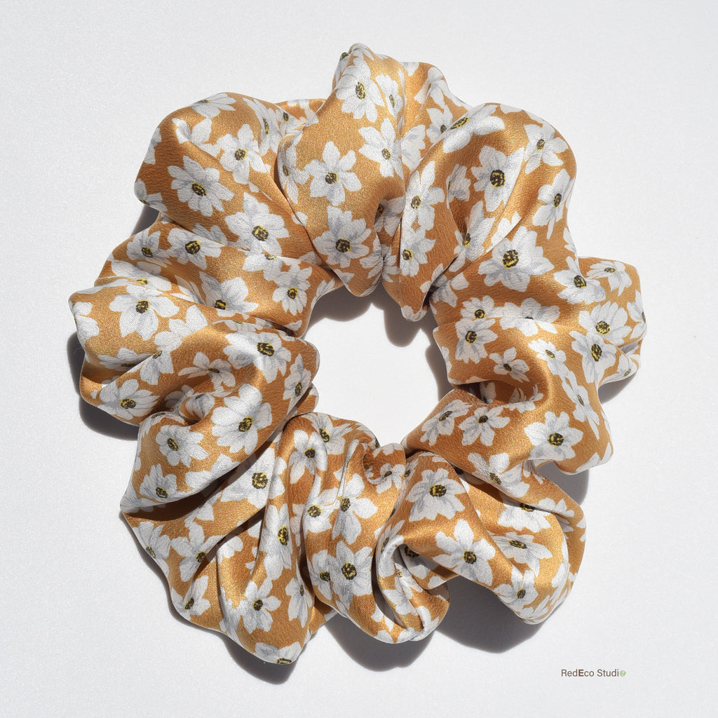 Large floral patterned silk scrunchie on a white background