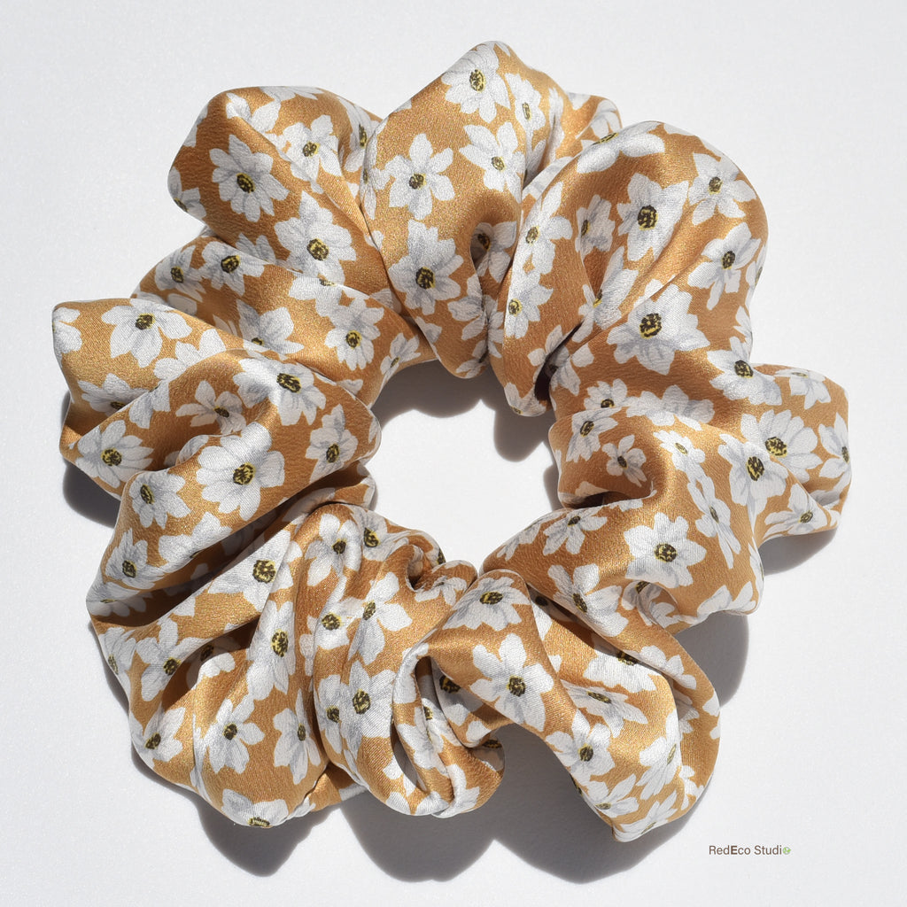 Large floral patterned silk scrunchie on a white background