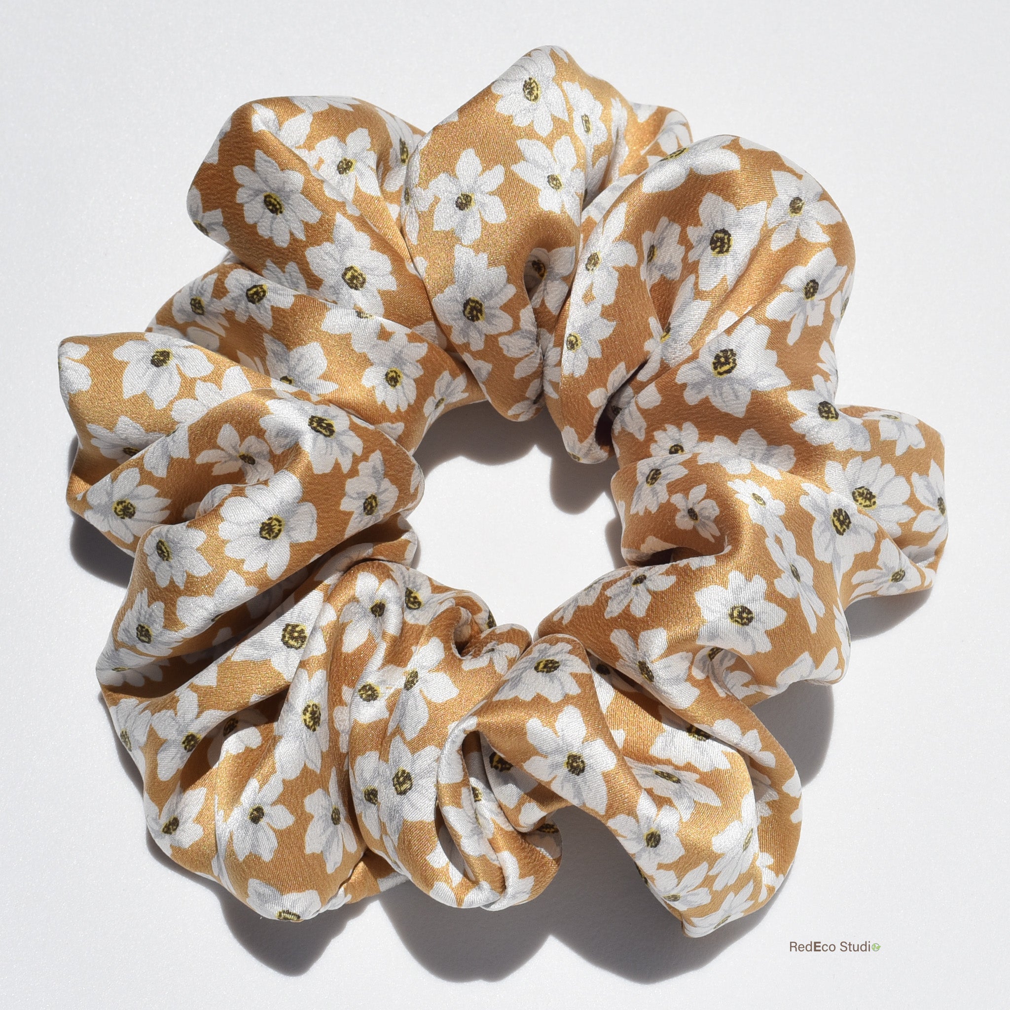 Large floral patterned silk scrunchie on a white background