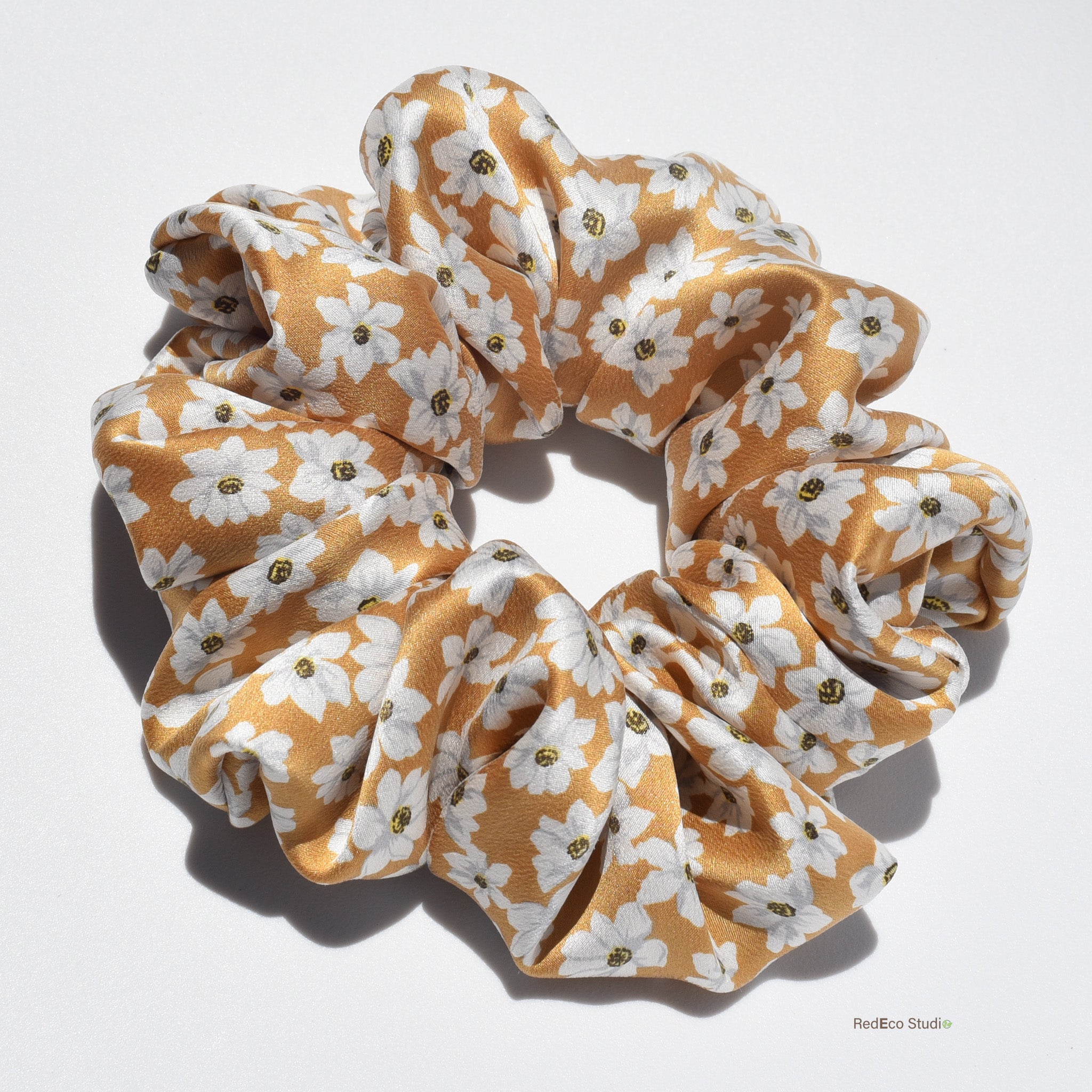 Large floral patterned silk scrunchie on a white background