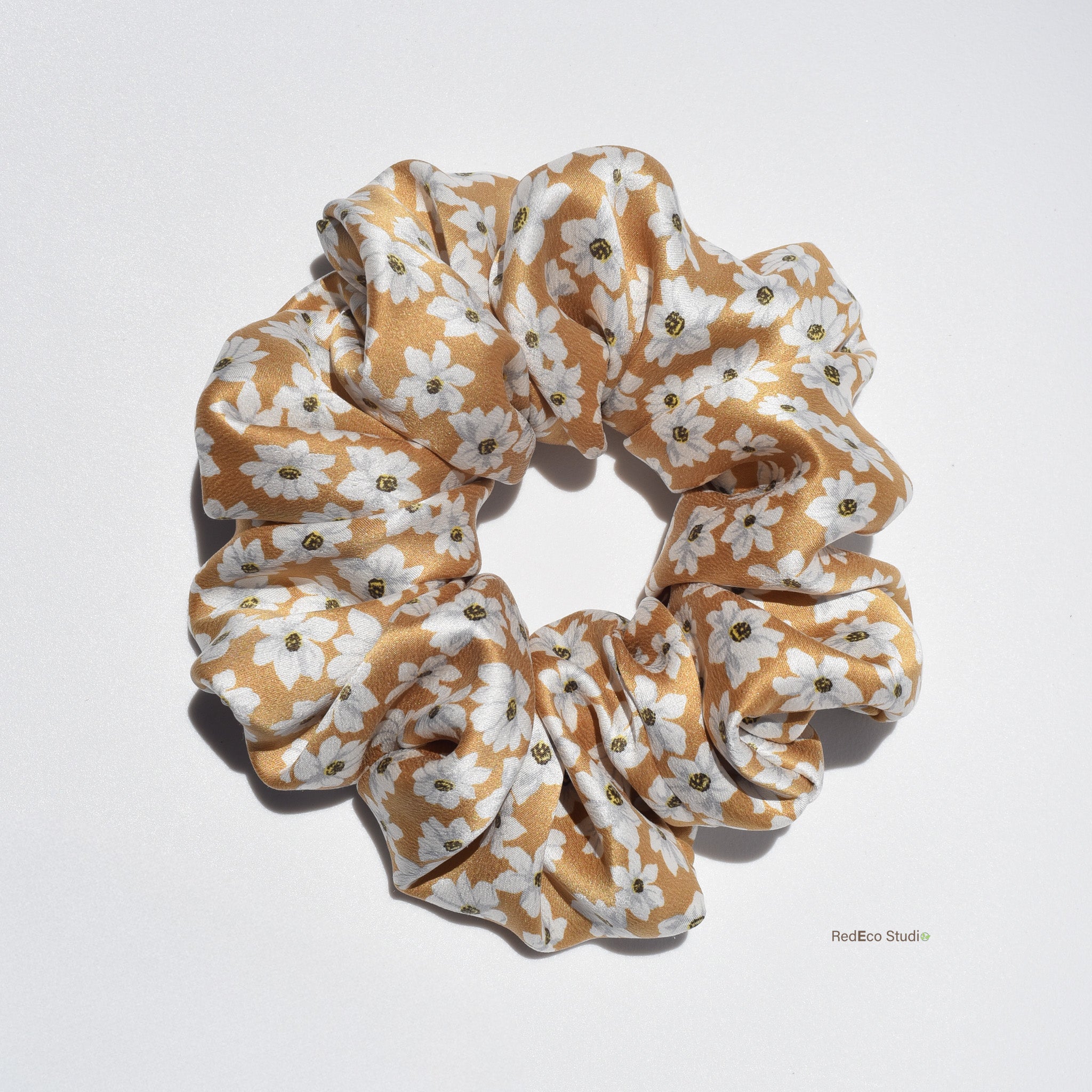 Large floral patterned silk scrunchie on a light gray background