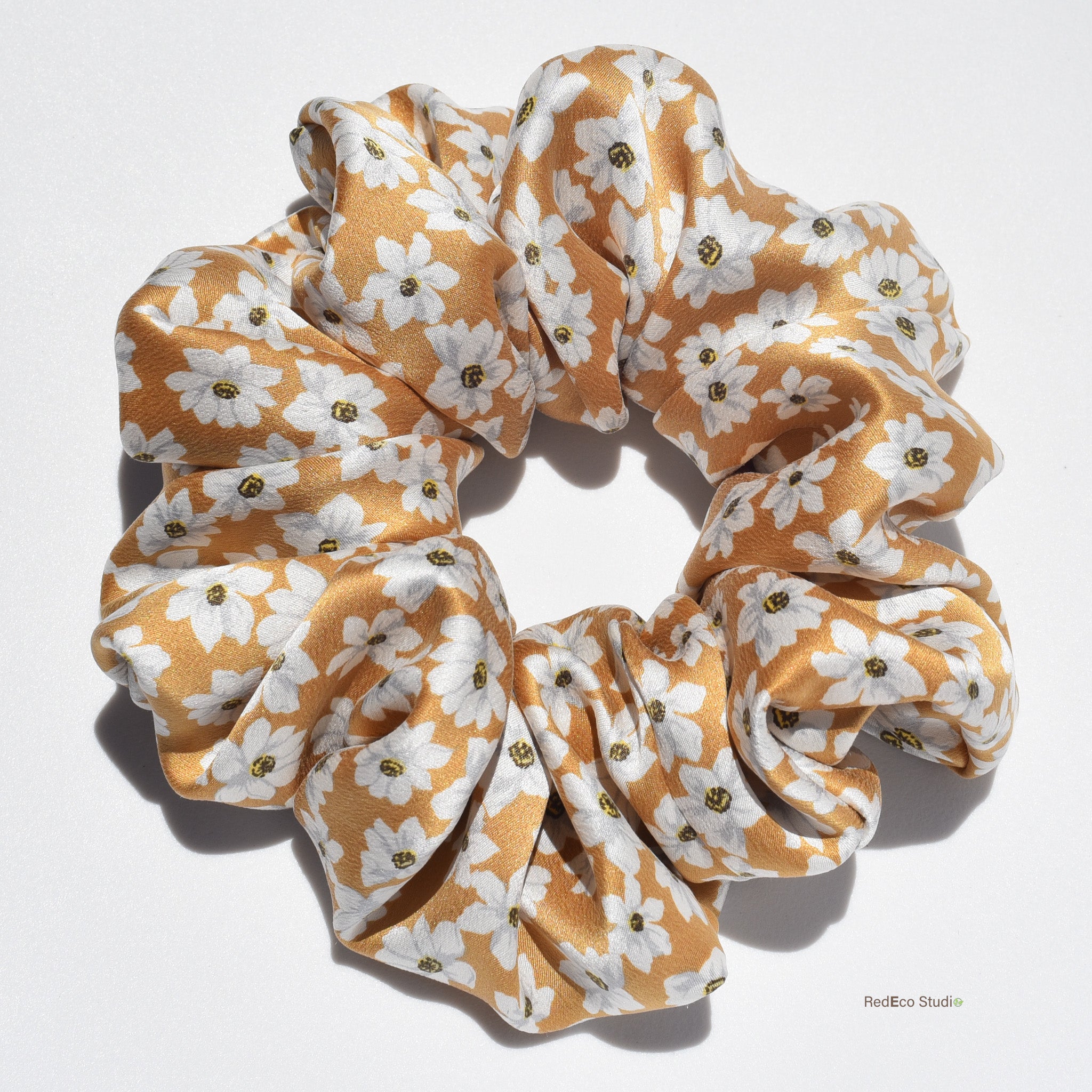 Large floral patterned silk scrunchie on a white background