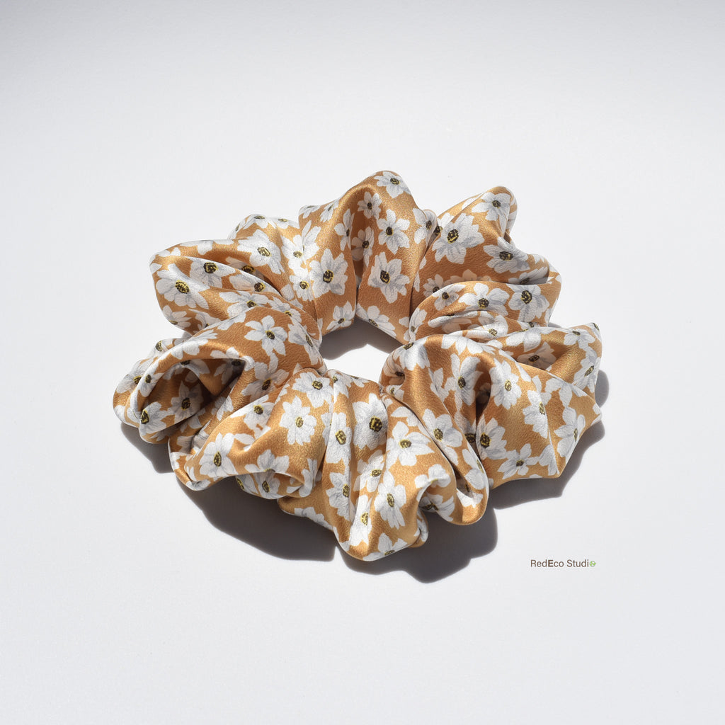 Large floral patterned silk scrunchie on a white background