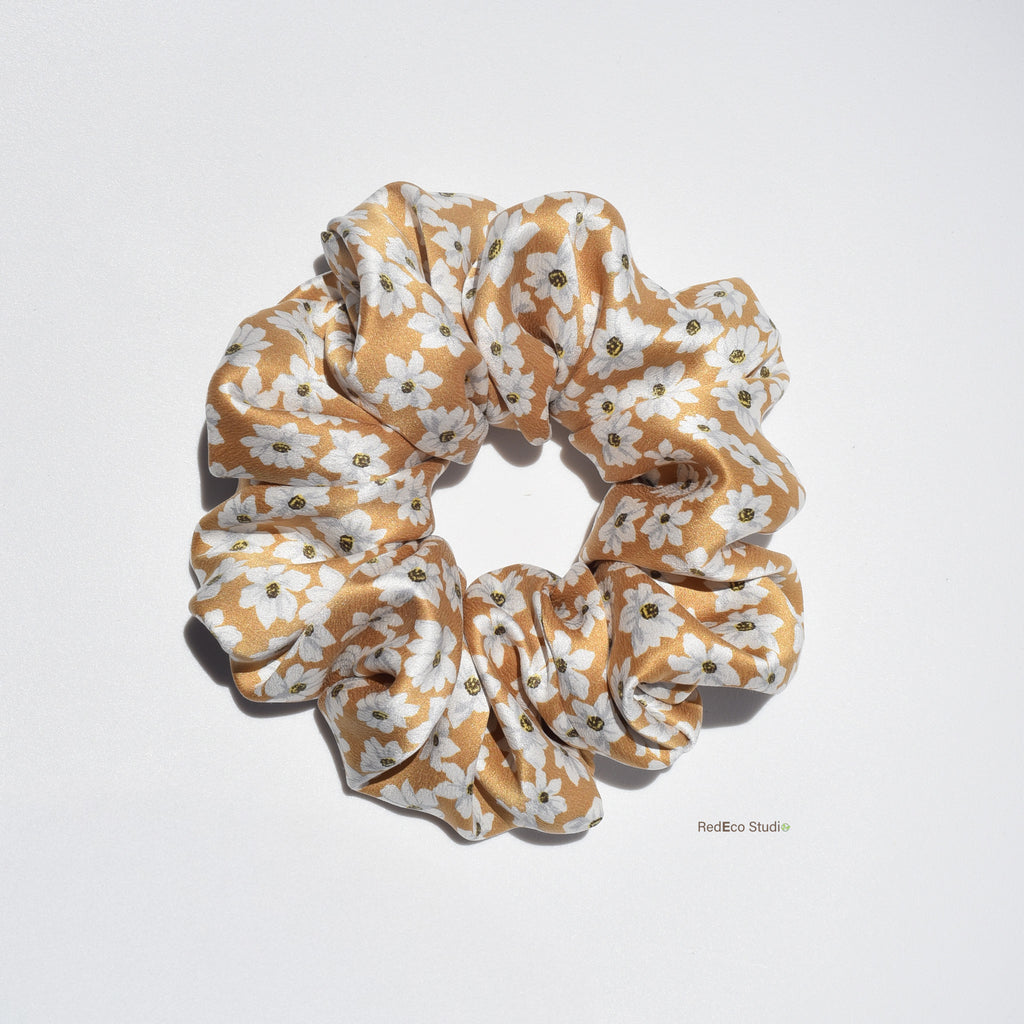 Large floral patterned silk scrunchie on a light gray background