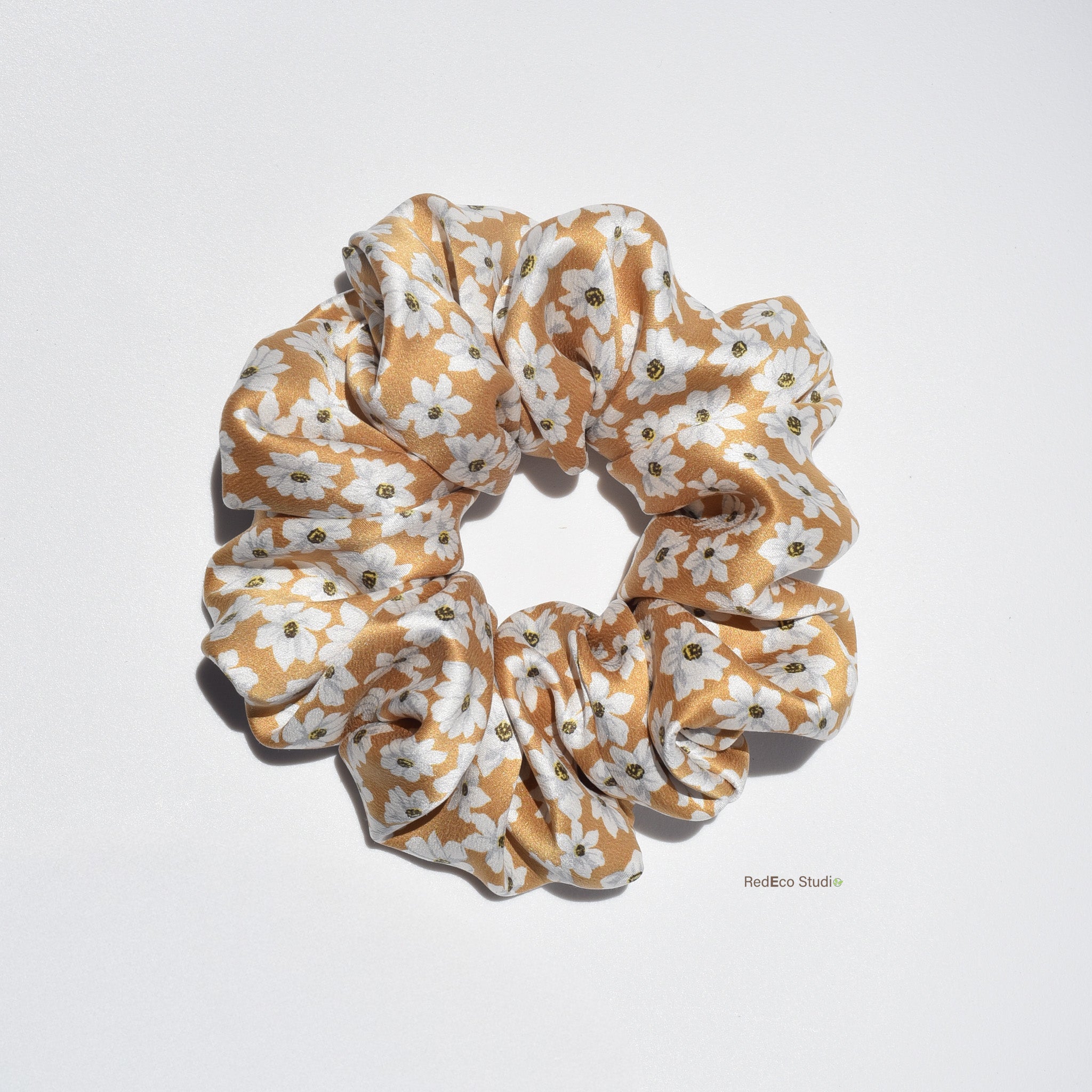 Large floral patterned silk scrunchie on a light gray background