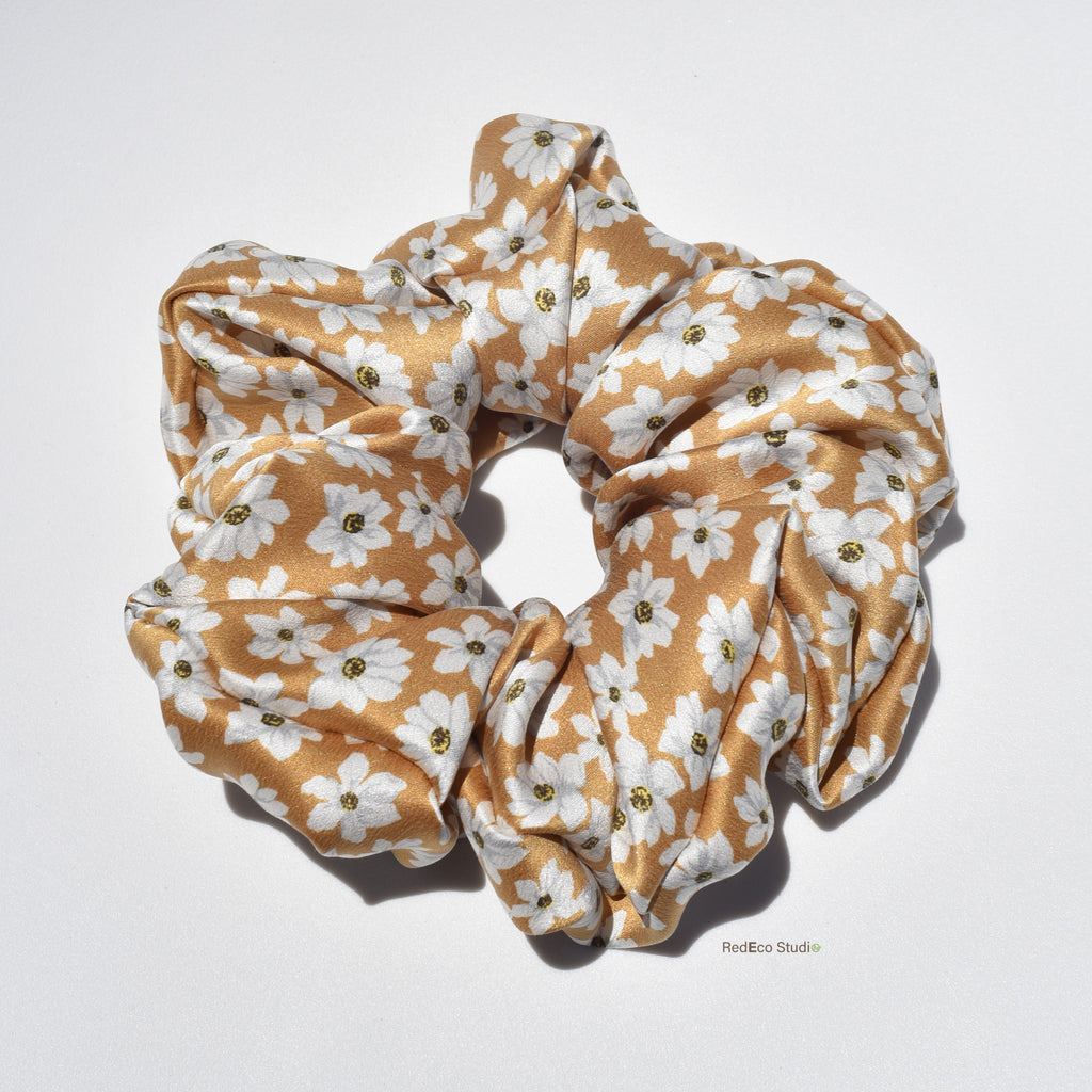 Large floral patterned silk scrunchie on a white background