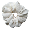 RedEco Studio oversized silk scrunchie in high-luster ivory cream, flat lay top view.