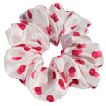 White silk scrunchie with two-tone red spots on a white background