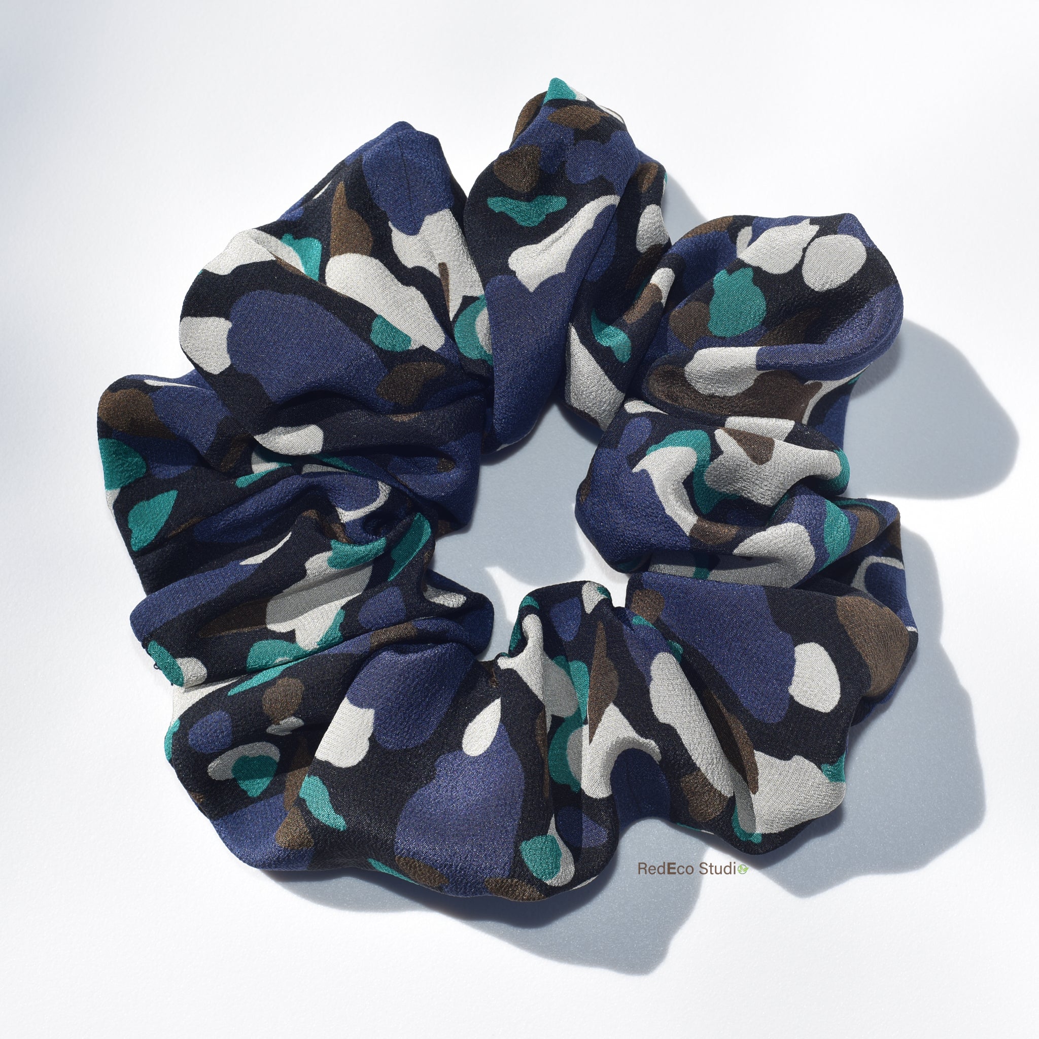 Multicolored silk scrunchie on a white background