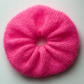 Extra large hand-knitted scrunchie in bright pink on a white background