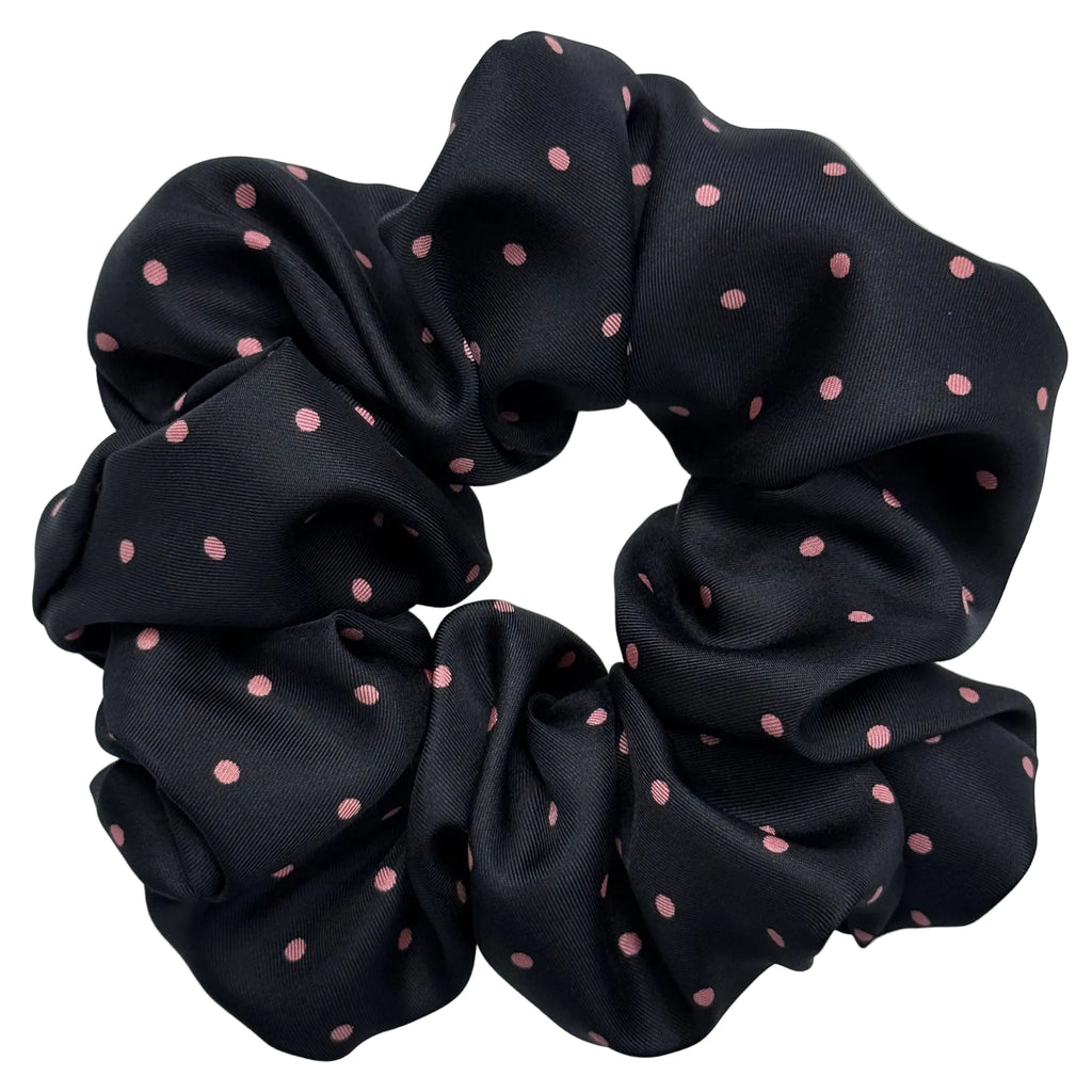Black scrunchie with pink polka dots on a white background
