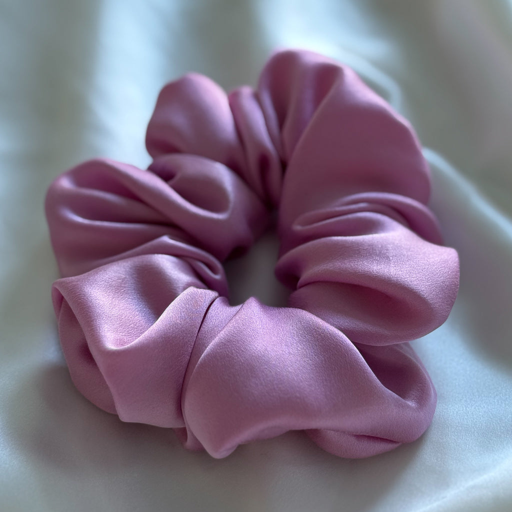 Pink silk scrunchie on a white background