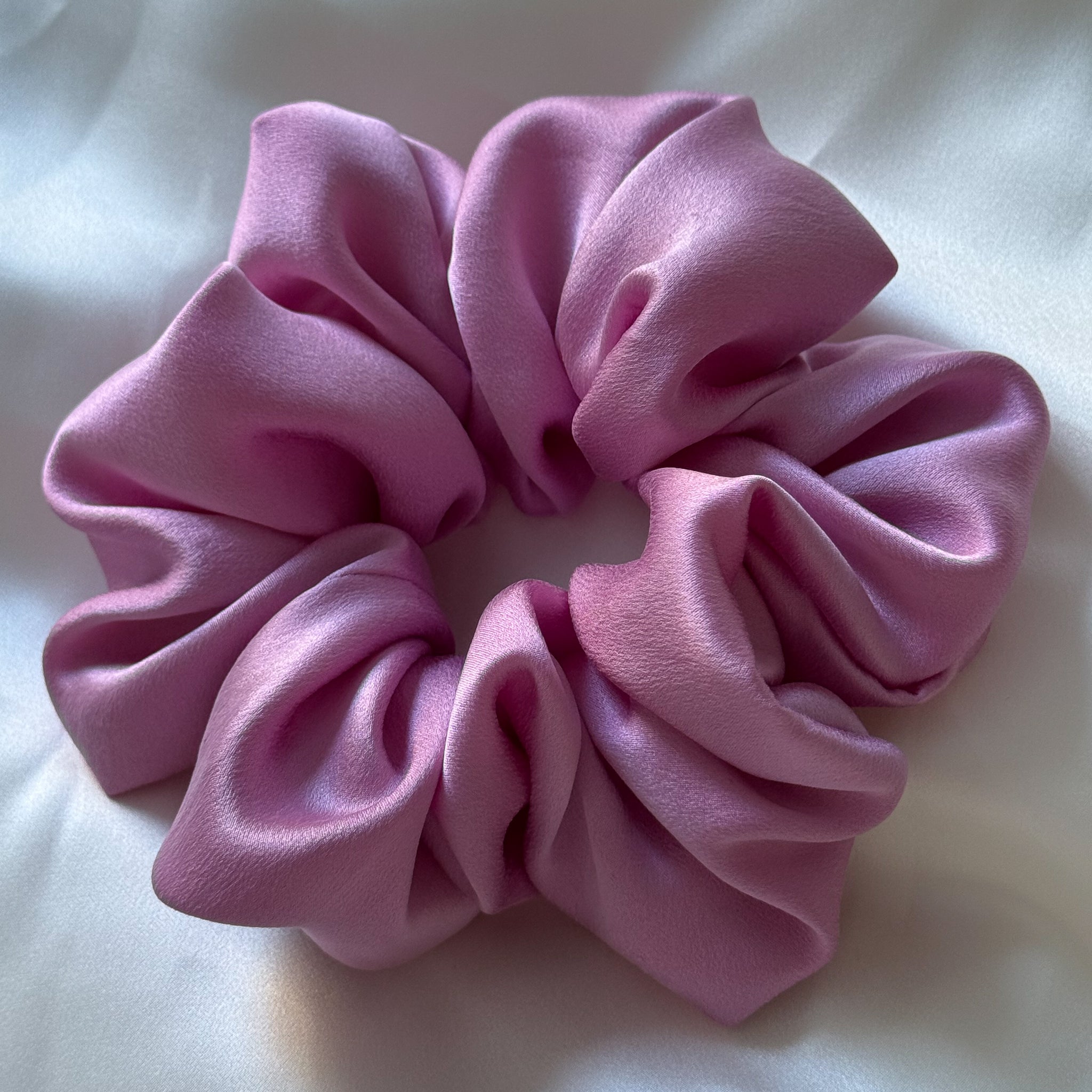 Pink scrunchie on a white background
