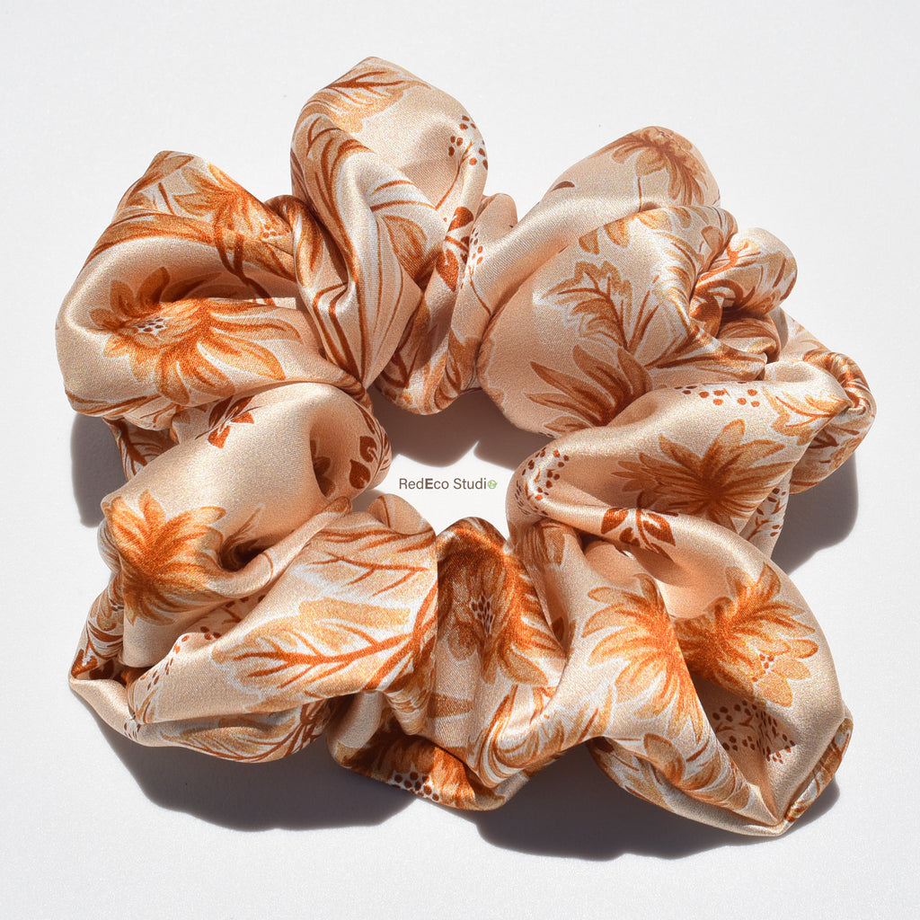 Floral patterned silk scrunchie on a white background