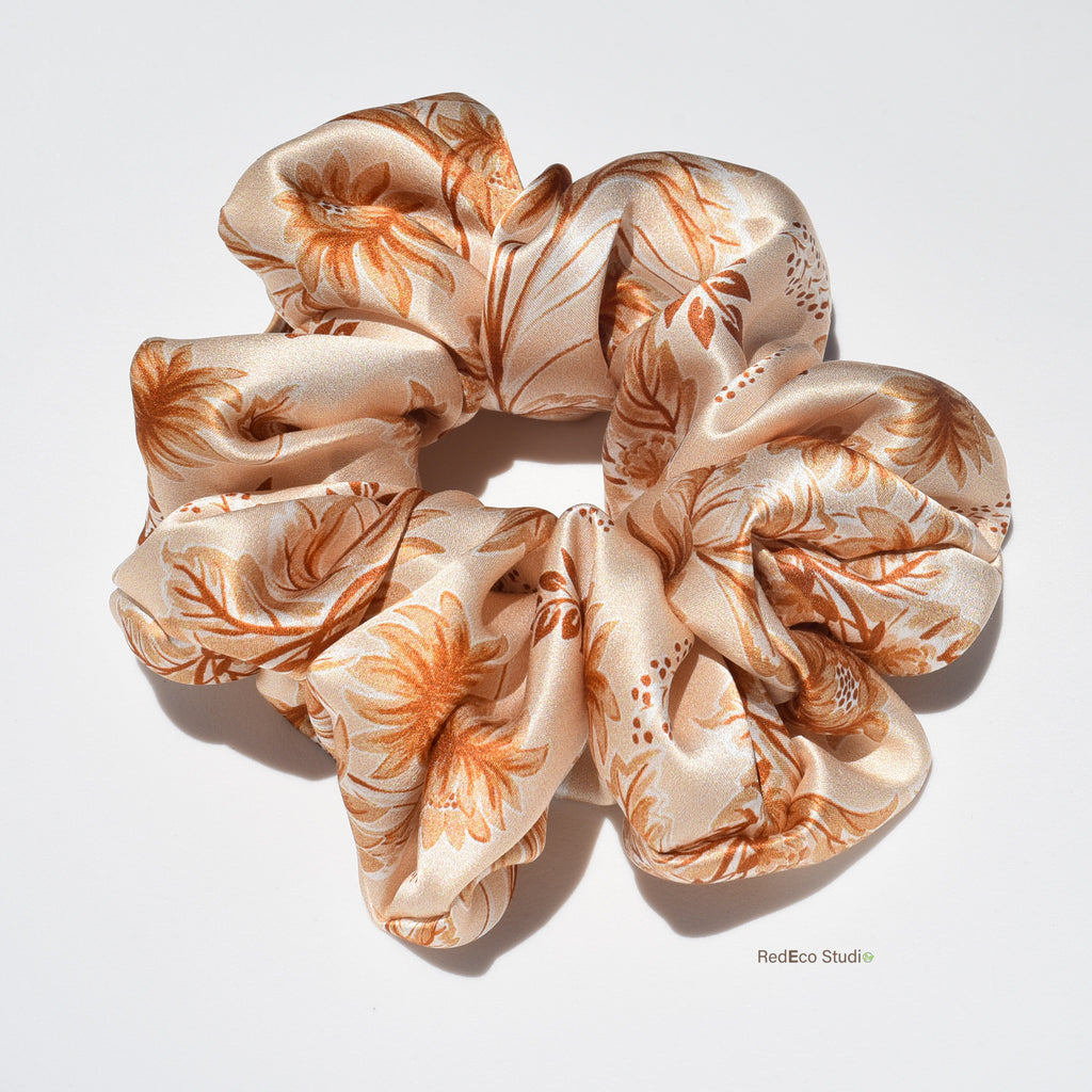 Floral patterned silk scrunchie on a light background