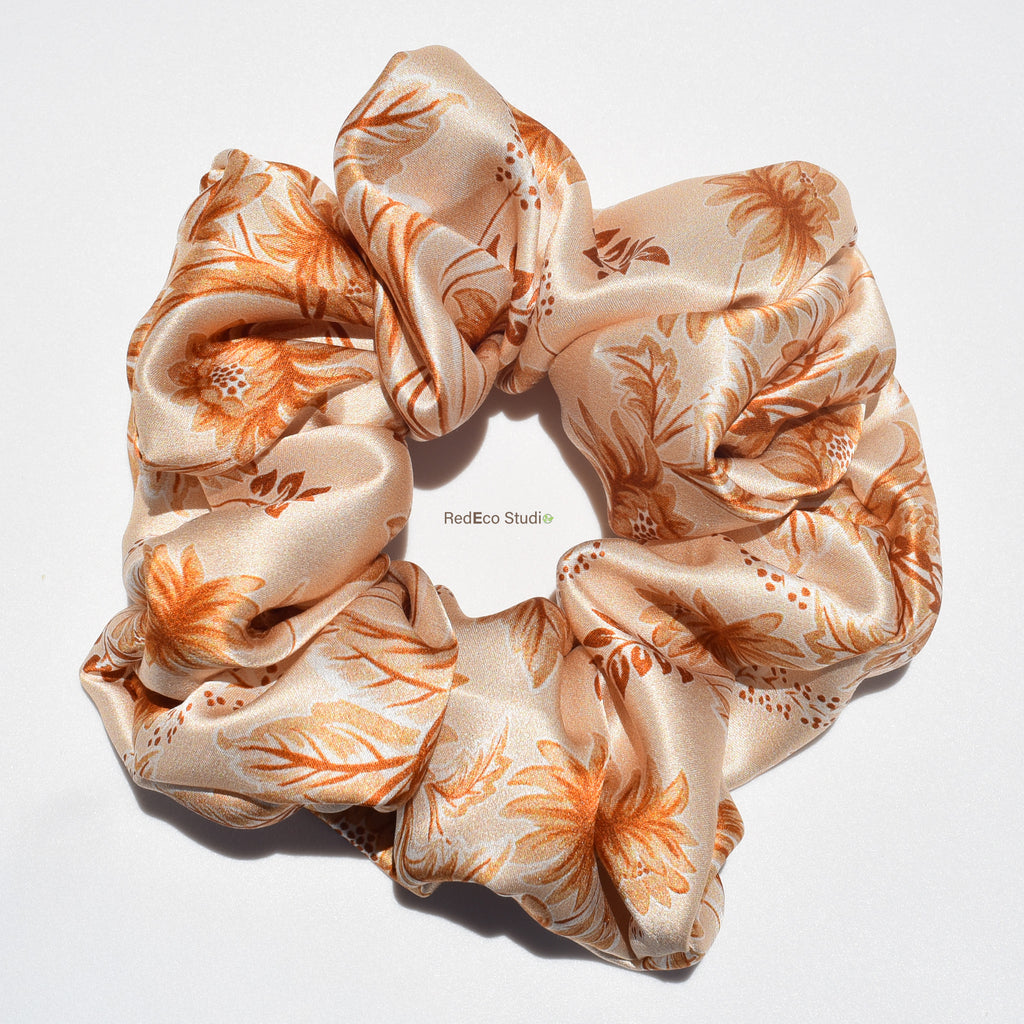 Floral patterned silk scrunchie on a white background