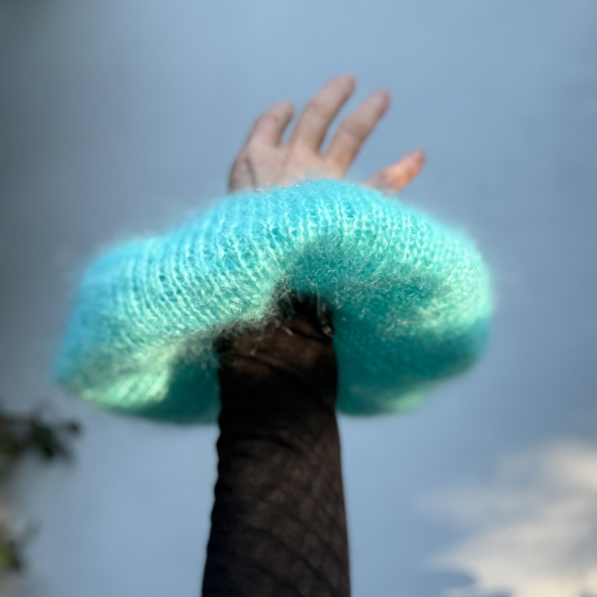 Oversized XL hand knitted silk mohair scrunchie in bright blue worn on wrist outdoors — handmade in Australia | RedEco Studio