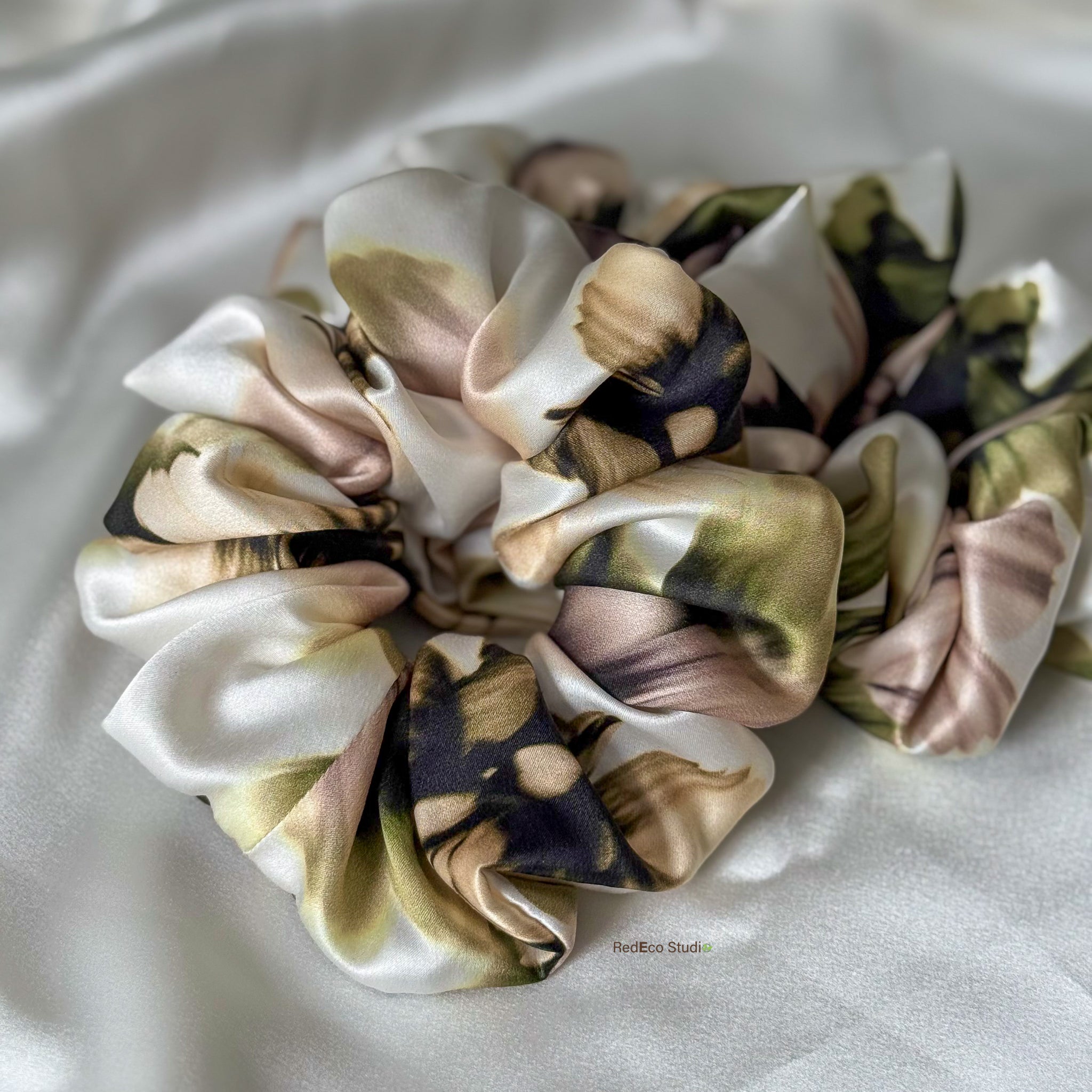 Floral silk scrunchies on a white background