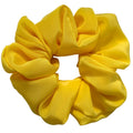 Yellow scrunchie on a white background