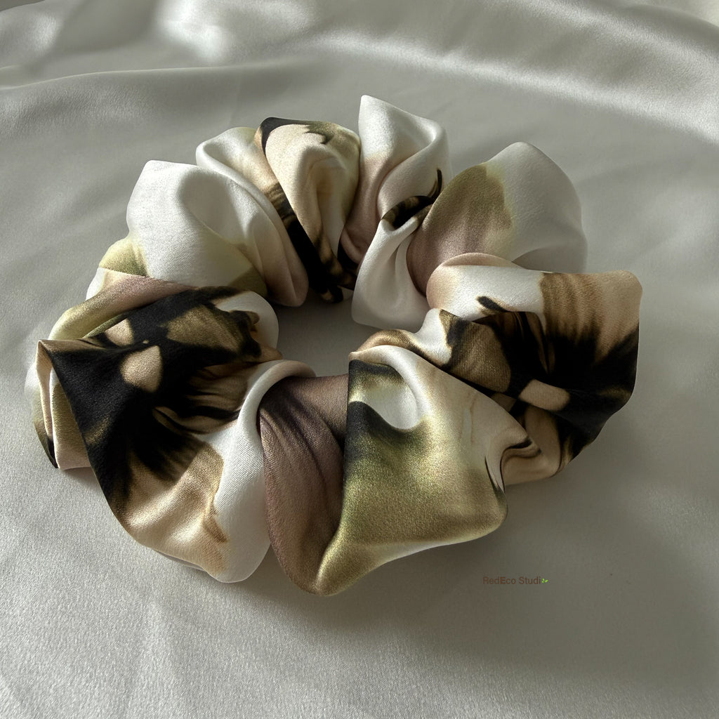 Silk scrunchies on a light fabric background