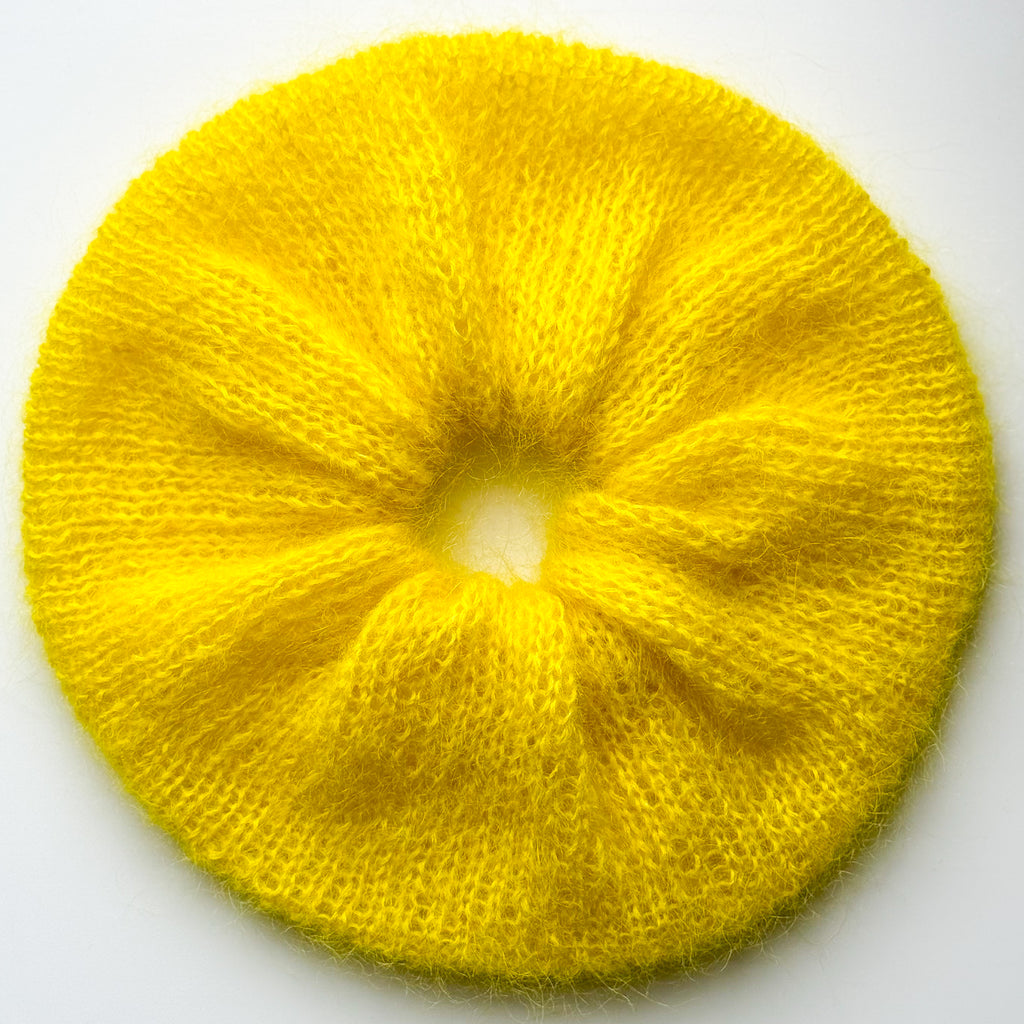 Extra Large bright yellow hand-knitted Scrunchie on a white background
