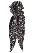 Patterned hair scrunchie and scarf on a white background
