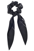 Black scrunchie with a long ribbon on a white background