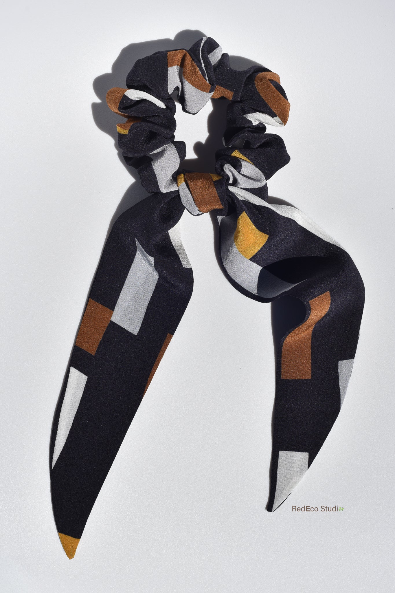 Classic 100% Silk Long Tail Scrunchie - Geometric pattern in white, steel, mustard, ochre on a navy blue base