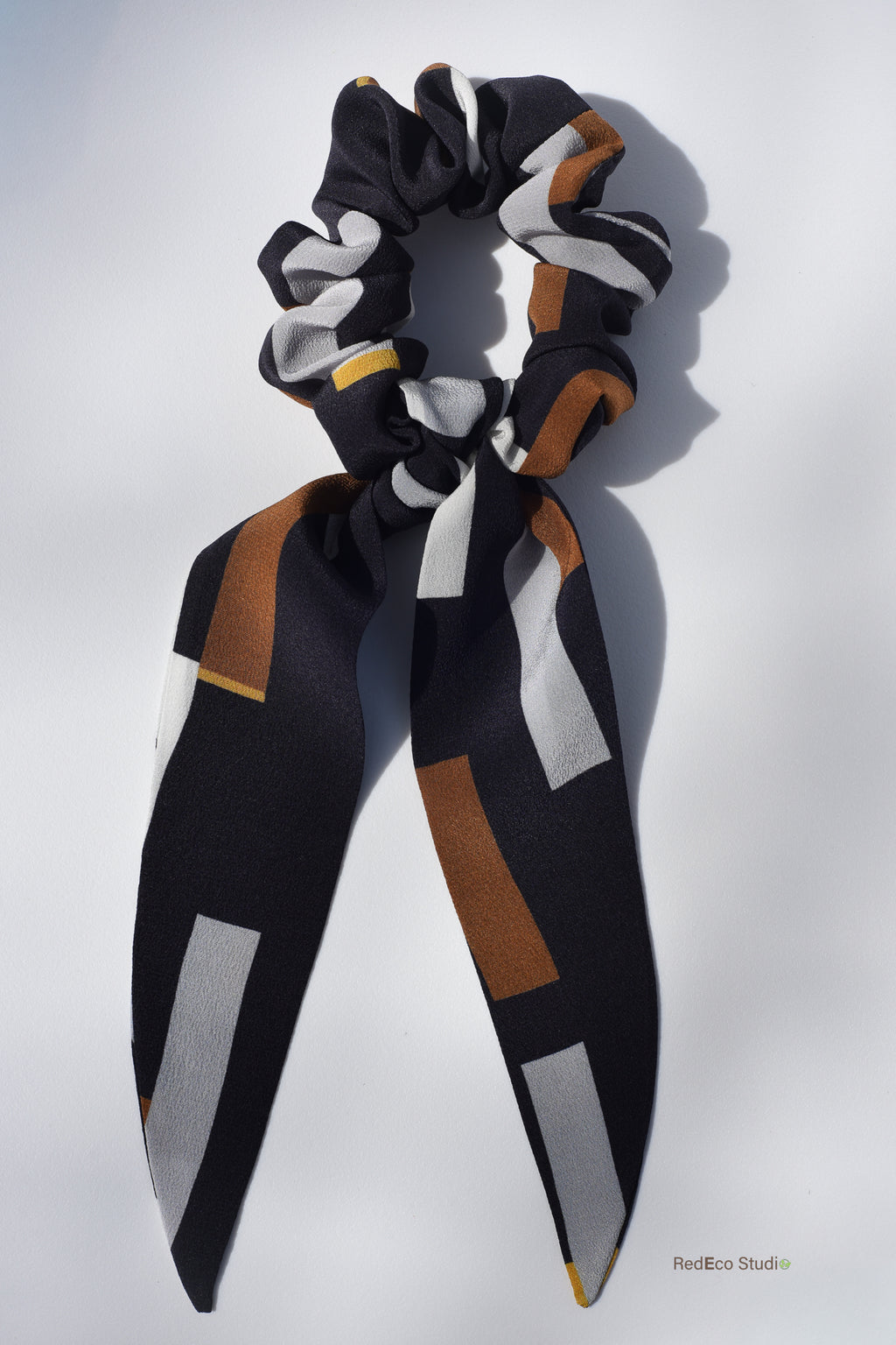 Classic 100% Silk Long Tail Scrunchie - Geometric pattern in white, steel, mustard, ochre on a navy blue base