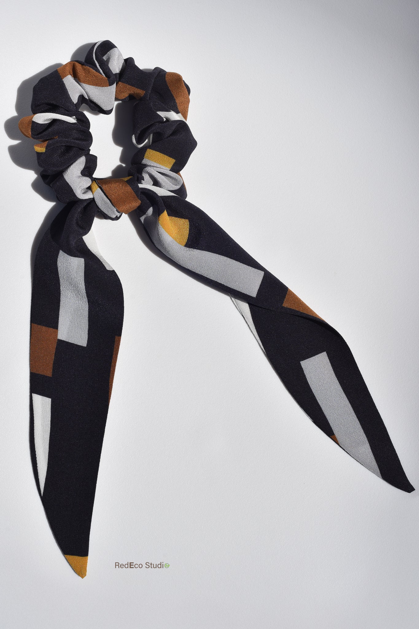 Classic 100% Silk Long Tail Scrunchie - Geometric pattern in white, steel, mustard, ochre on a navy blue base