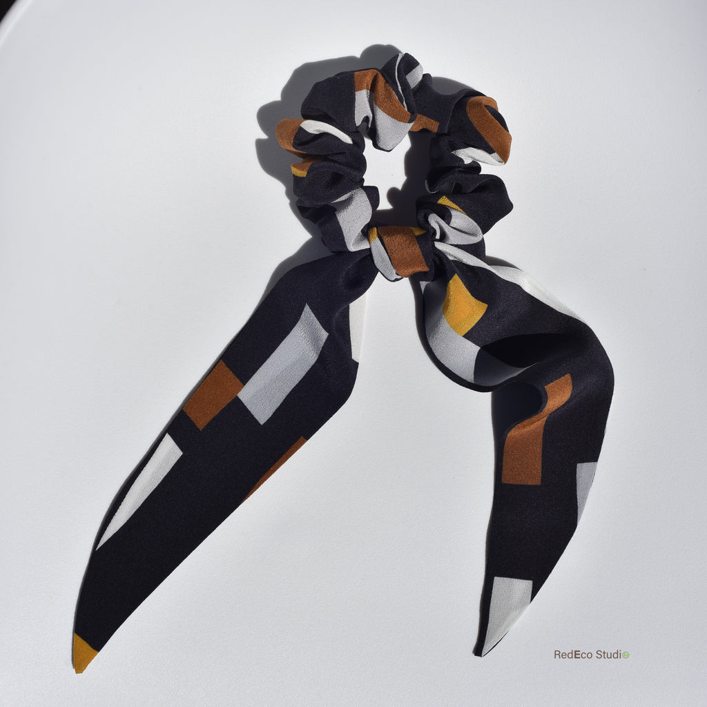 Scarf silk scrunchie with geometric pattern on a white background