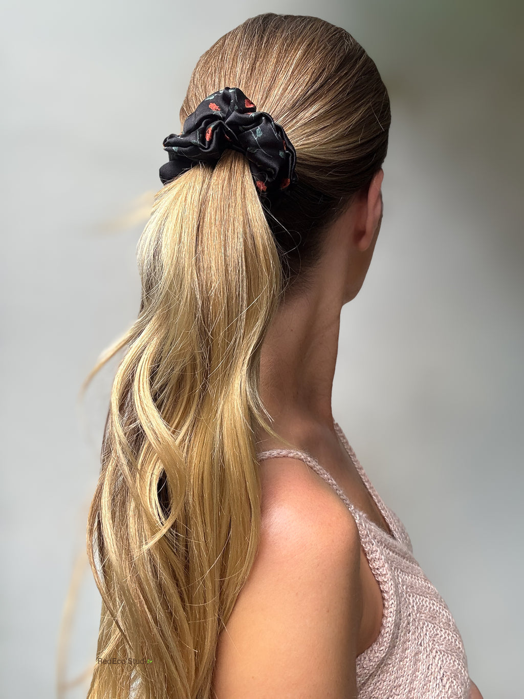 Ember Rose silk scrunchie on a sleek high ponytail, worn without its tails, back view