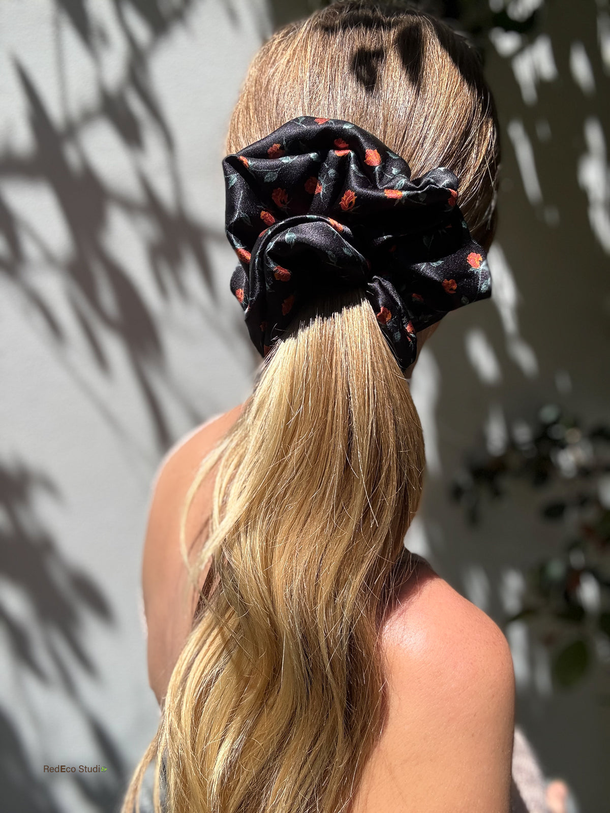Black rose print oversized silk scrunchie on a high ponytail, back view