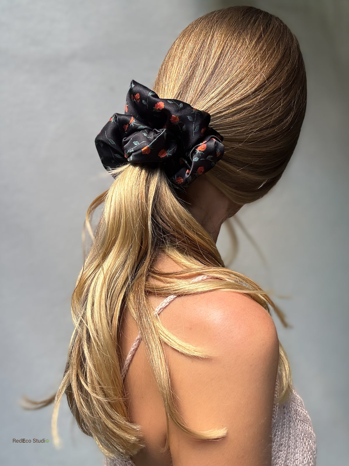 Ember Rose oversized silk scrunchie on a low ponytail, side view